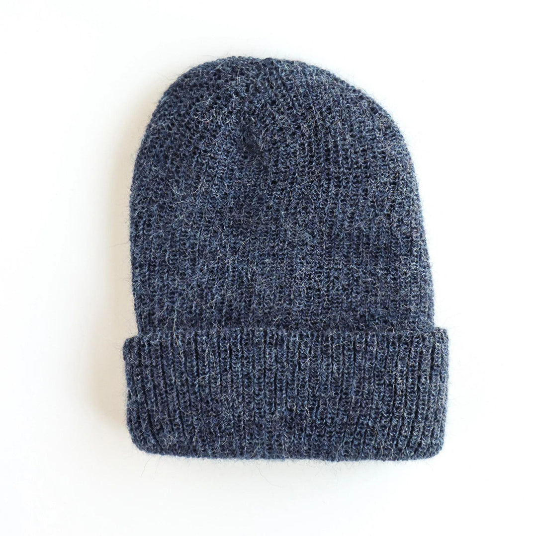 Blue knit beanie on a white background