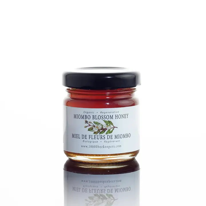 mini jar of miombo blossom honey on a white background