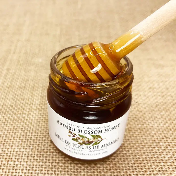 mini jar of miombo blossom honey with honey dipper