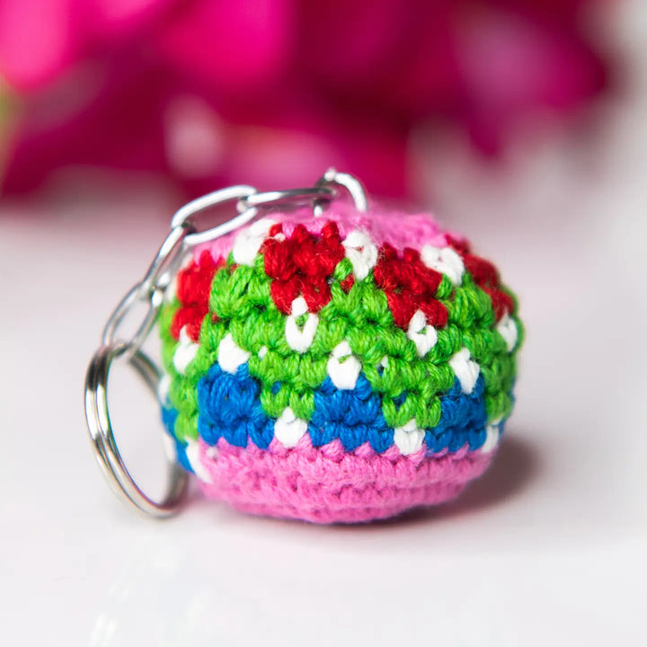 Colorful crocheted keychain with a pattern on a light background