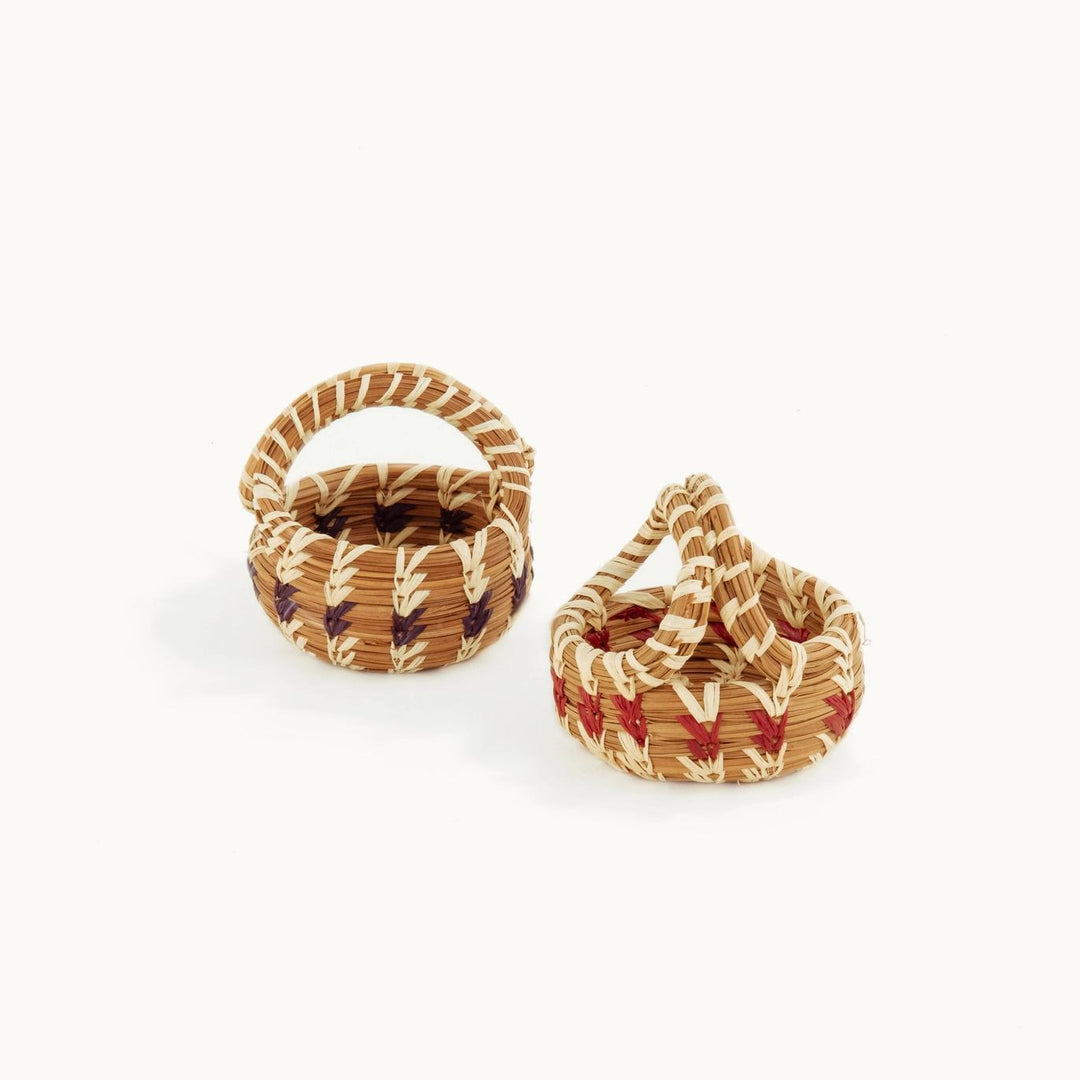 Two mini woven baskets on a white background