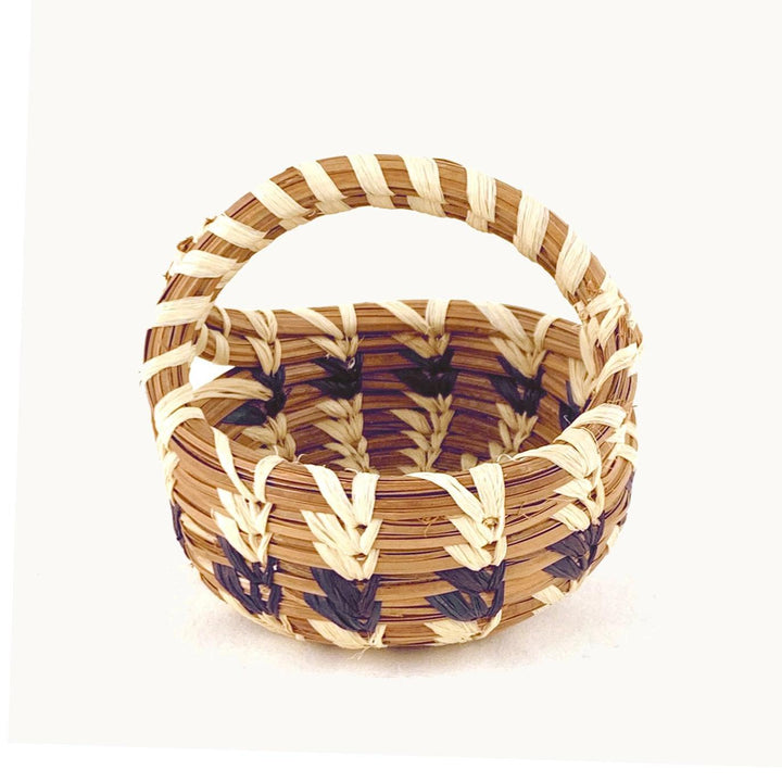Mini woven basket with a handle on a white background