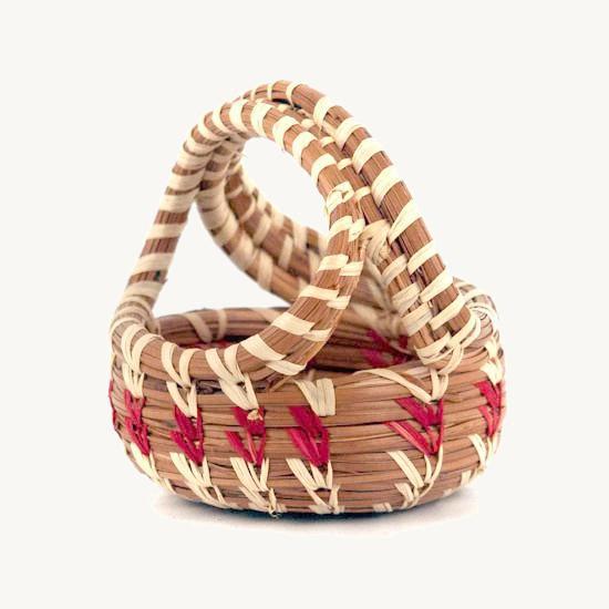 Mini woven basket with a handle and pink stripes on a white background