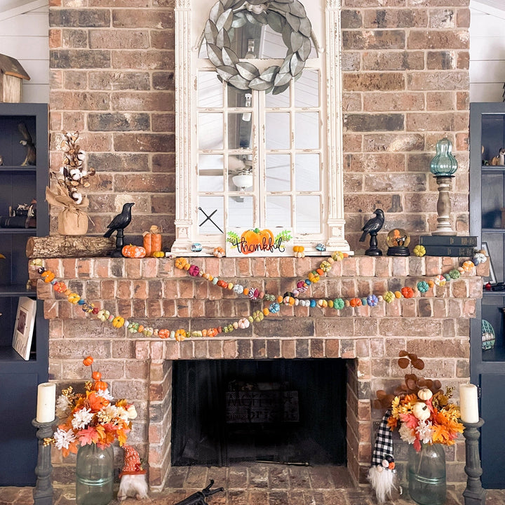 Brick fireplace with decorative items and a wreath above it.