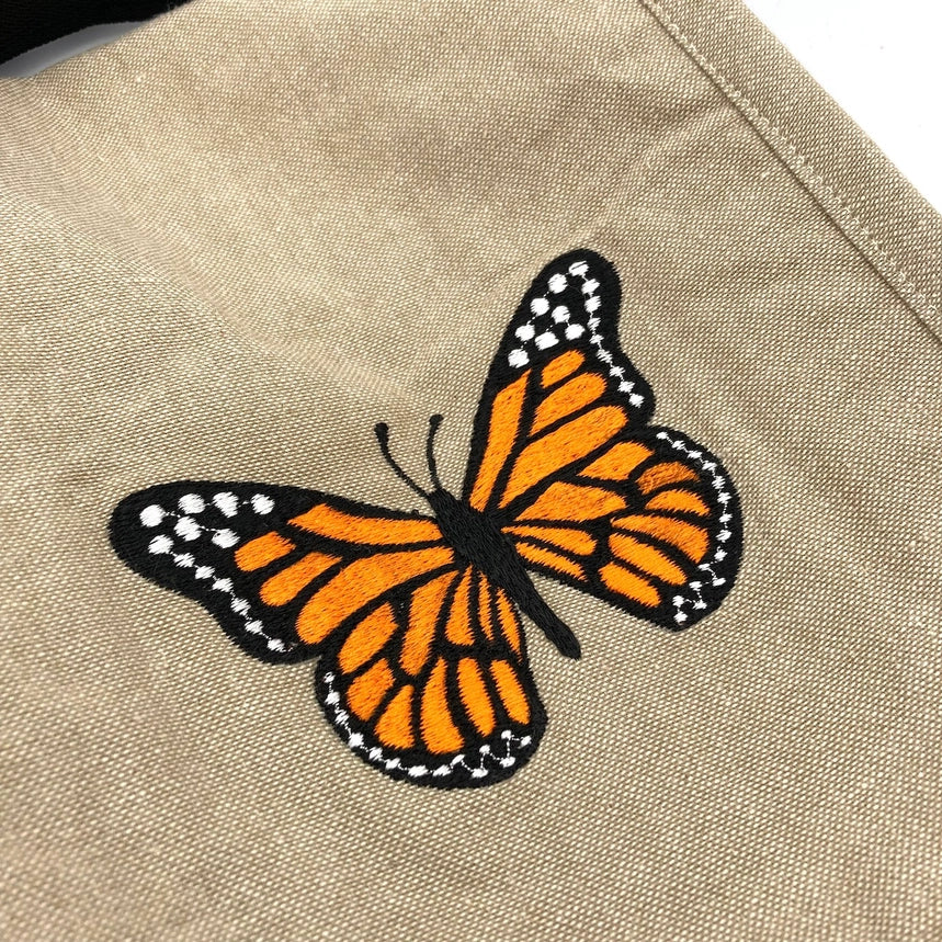 Butterfly patch on a beige fabric background