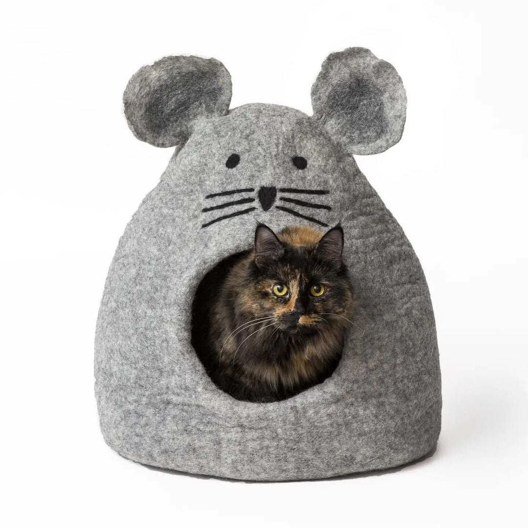 Cat inside a gray mouse-shaped pet cave on a white background