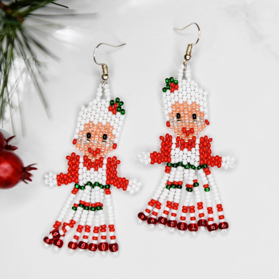 Beaded earrings shaped like dolls on a white background