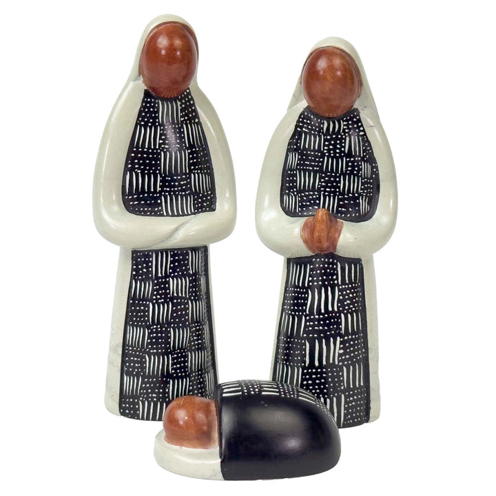 Mary and Joseph soapstone figures with baby Jesus in a black and white design on a white background. 