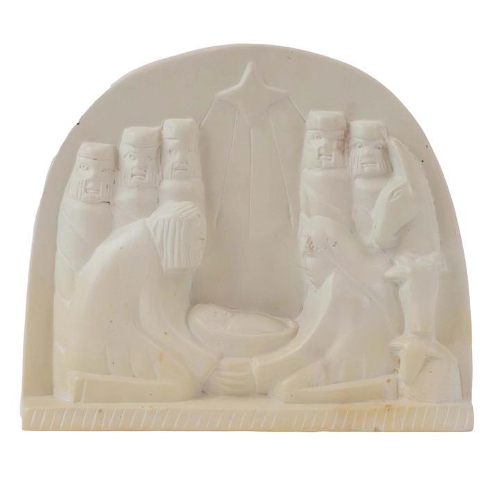 A hand-carved nativity scene plaque made from natural kisii stone with shades of cream, gray, pink, and brown.