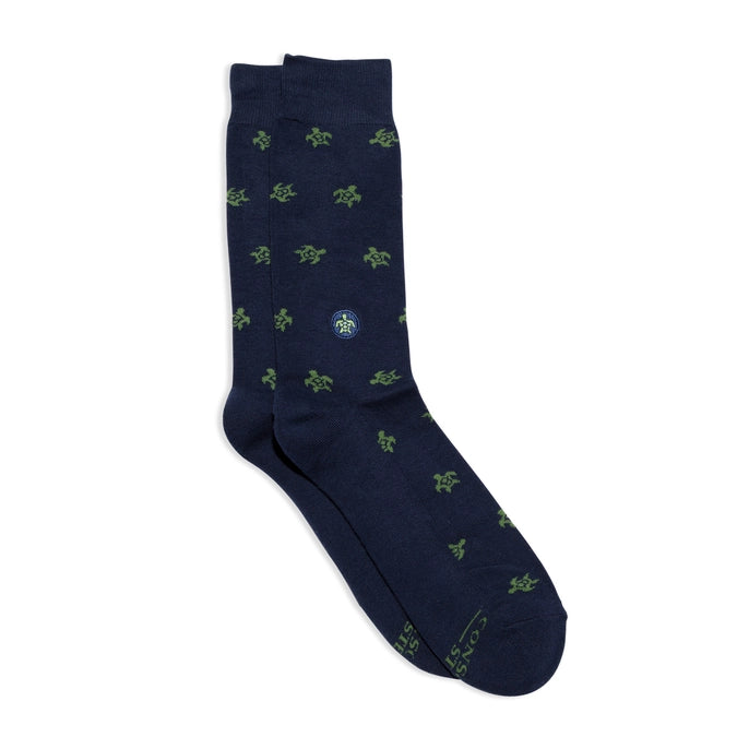 Navy sock with green turtle pattern on a white background