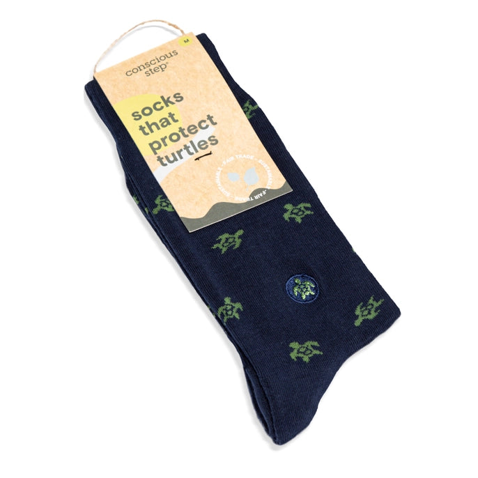 Navy blue socks with green turtle patterns featuring 'Conscious Step' packaging.