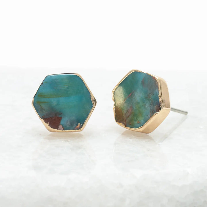 Hexagonal turquoise stone earrings with gold accents on a white background