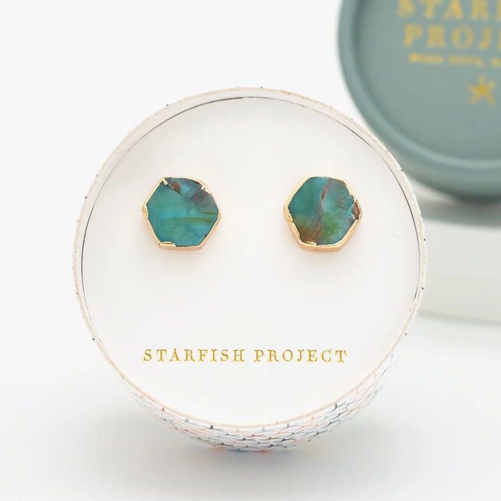 Turquoise earrings with gold accents in a 'Starfish Project' box on a white background