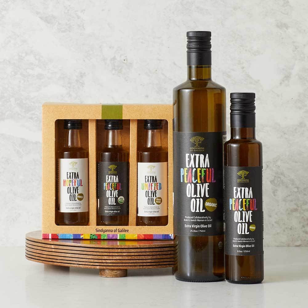 Set of olive oil bottles with 'Extra Peaceful Olive Oil' branding on a light background