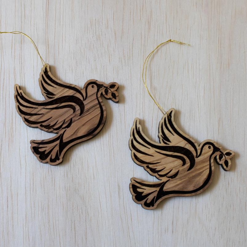 Olive wood dove ornaments on wooden table