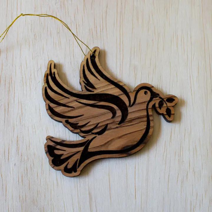 Olive wood peach dove ornament on display