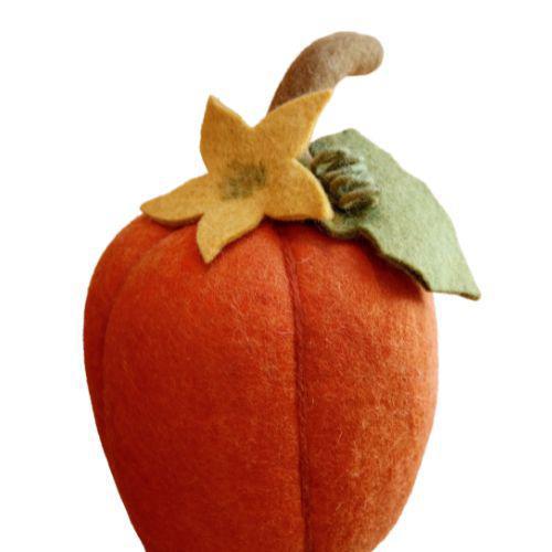 Handcrafted felt pumpkin with an orange color, a green stem, and a yellow flower on top.
