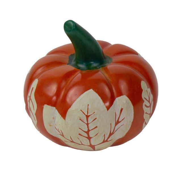 Decorative pumpkin with leaf designs on a white background