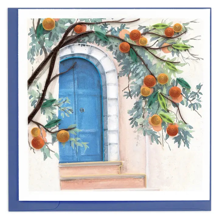 A square greeting card or art print featuring a painted scene of a blue arched door set in a cream wall, with orange branches and leaves draped across it. The card is shown against a blue background.