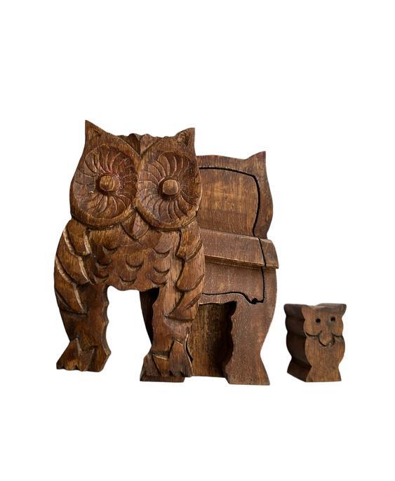 Hand-carved wooden puzzle box in the shape of an owl with a baby owl inside.