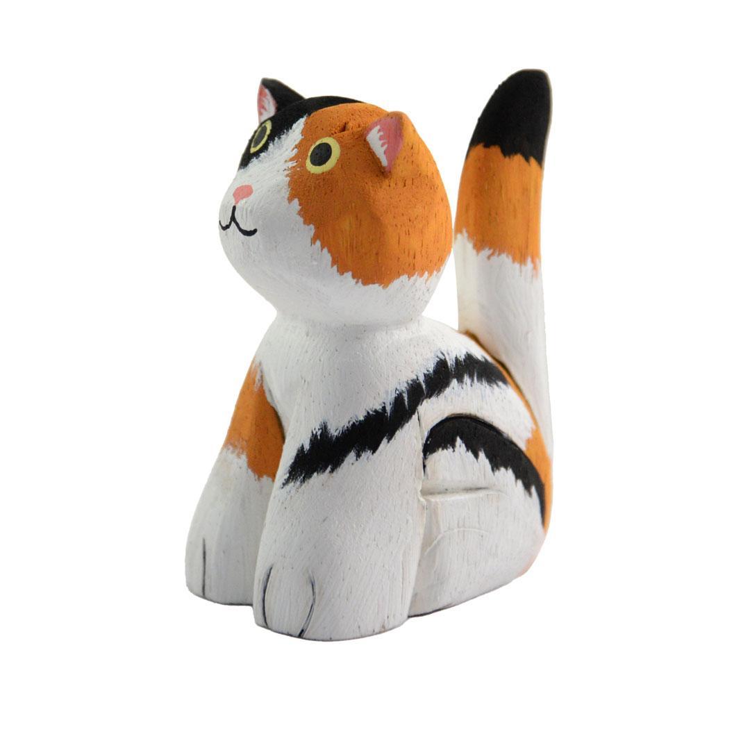 a calico painted balsa wood cat