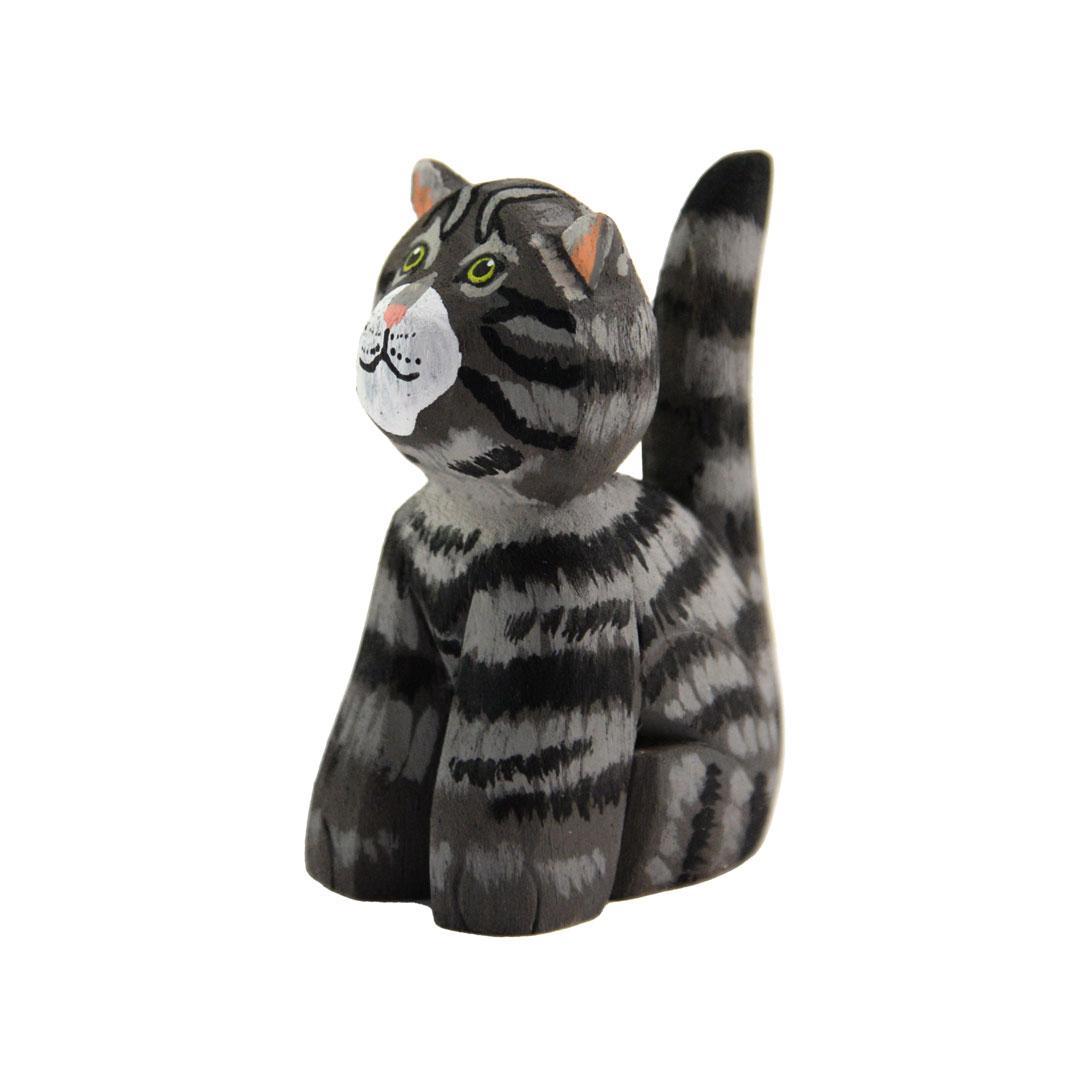 a grey painted balsa wood cat on a white background