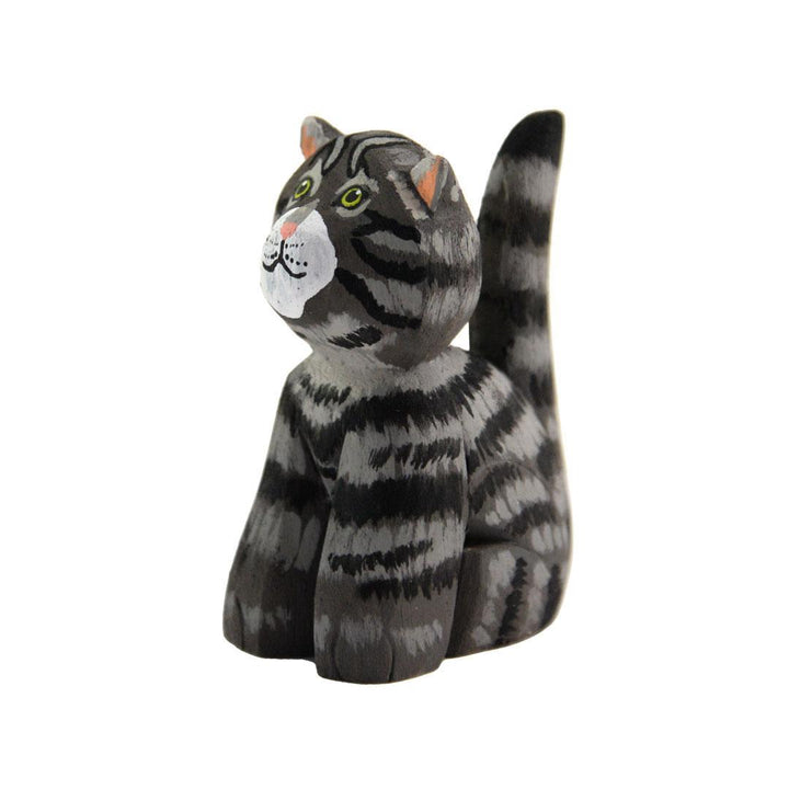 a grey painted balsa wood cat on a white background