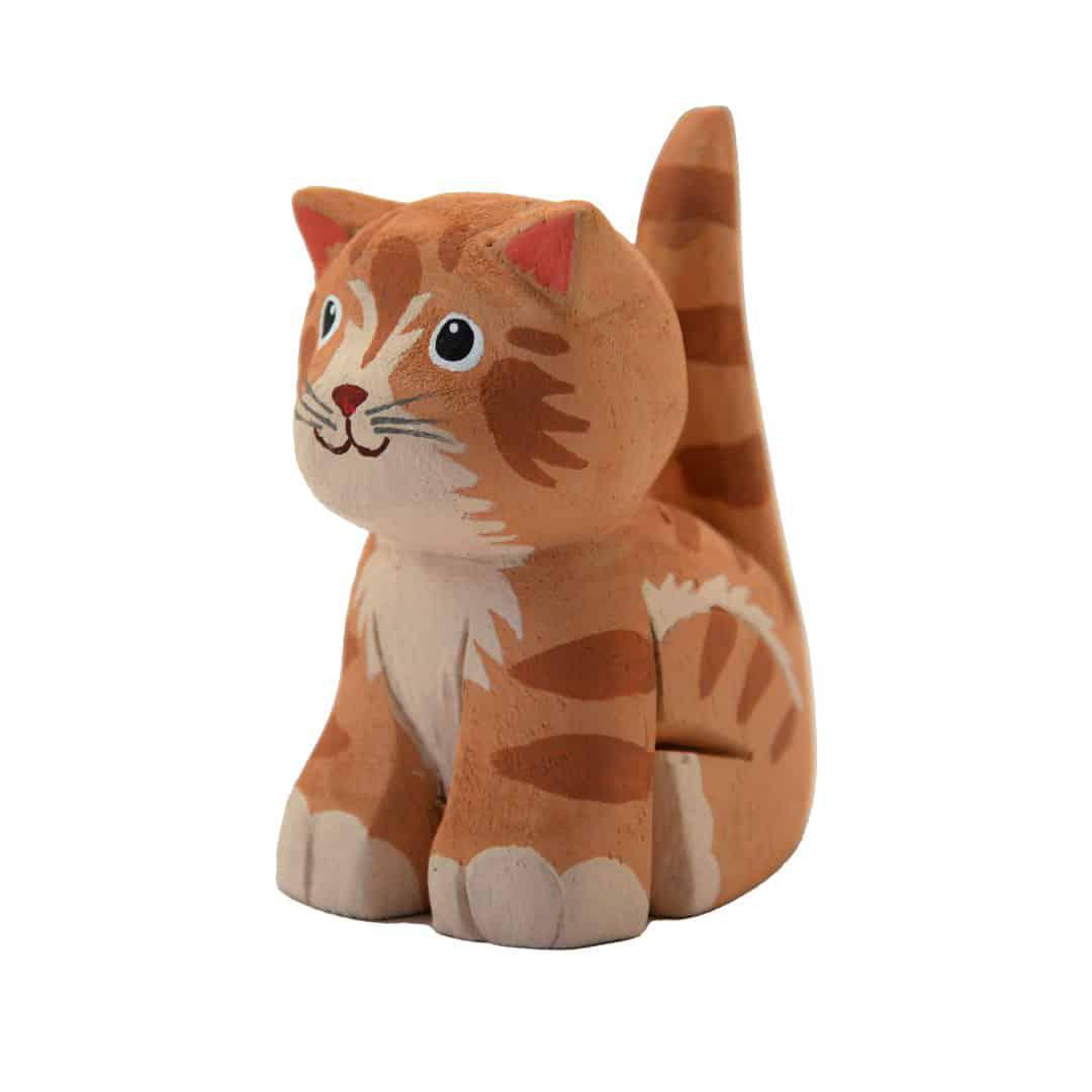 a painted balsa wood orange cat on a white background