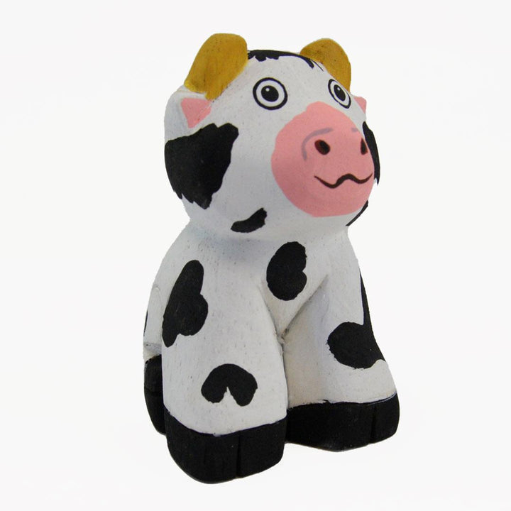 painted balsa wood cow on a white background