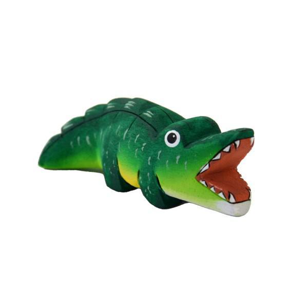 a painted balsa wood crocodile on a white background