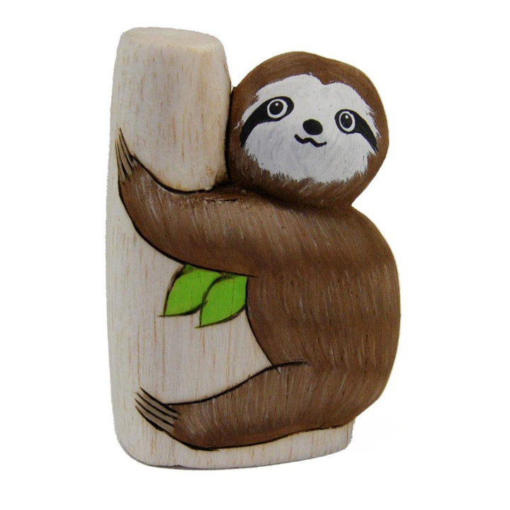 Wooden sloth figurine holding a branch with a green leaf on a white background
