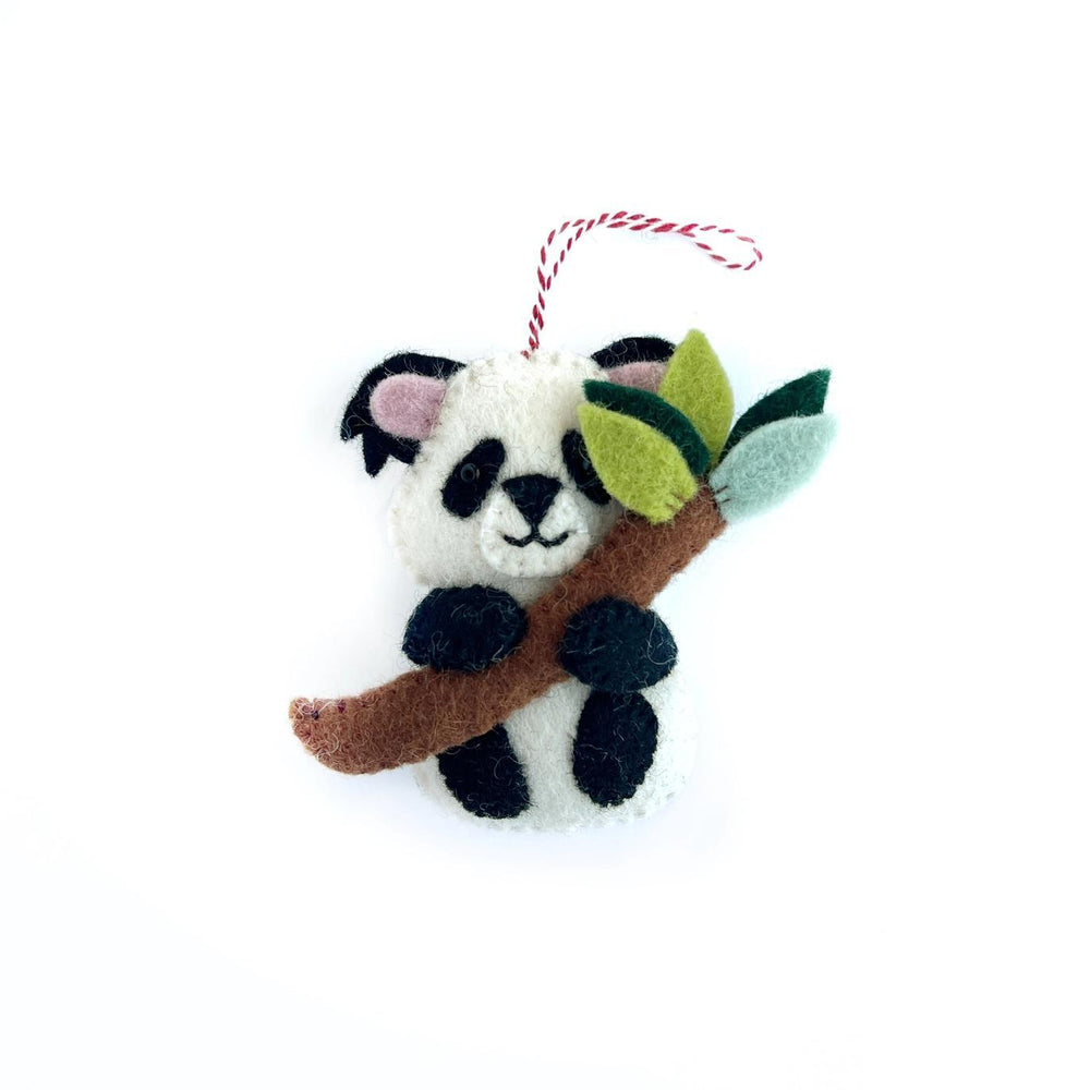 Felt panda ornament holding a branch with leaves on a white background