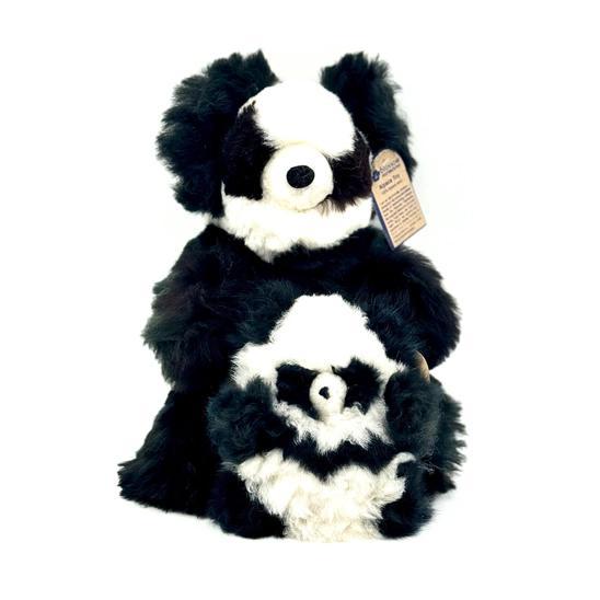 Two plush toys resembling pandas with black and white fur, made from recycled alpaca fur, standing upright.