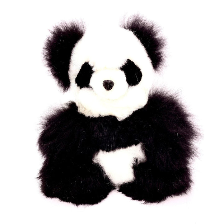 A plush toy resembling a panda bear with black and white fur, made from alpaca fur.