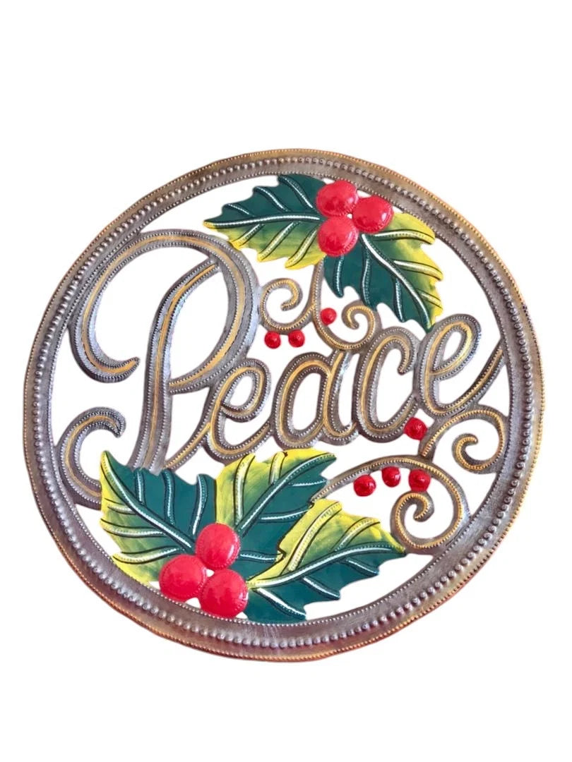round metal art with the word "peace" with holly and berries