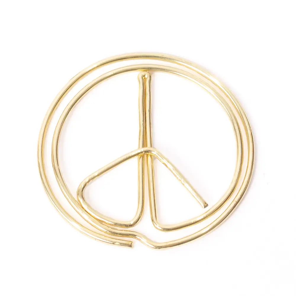 A gold-colored metal peace sign hoop earring on a solid white background.