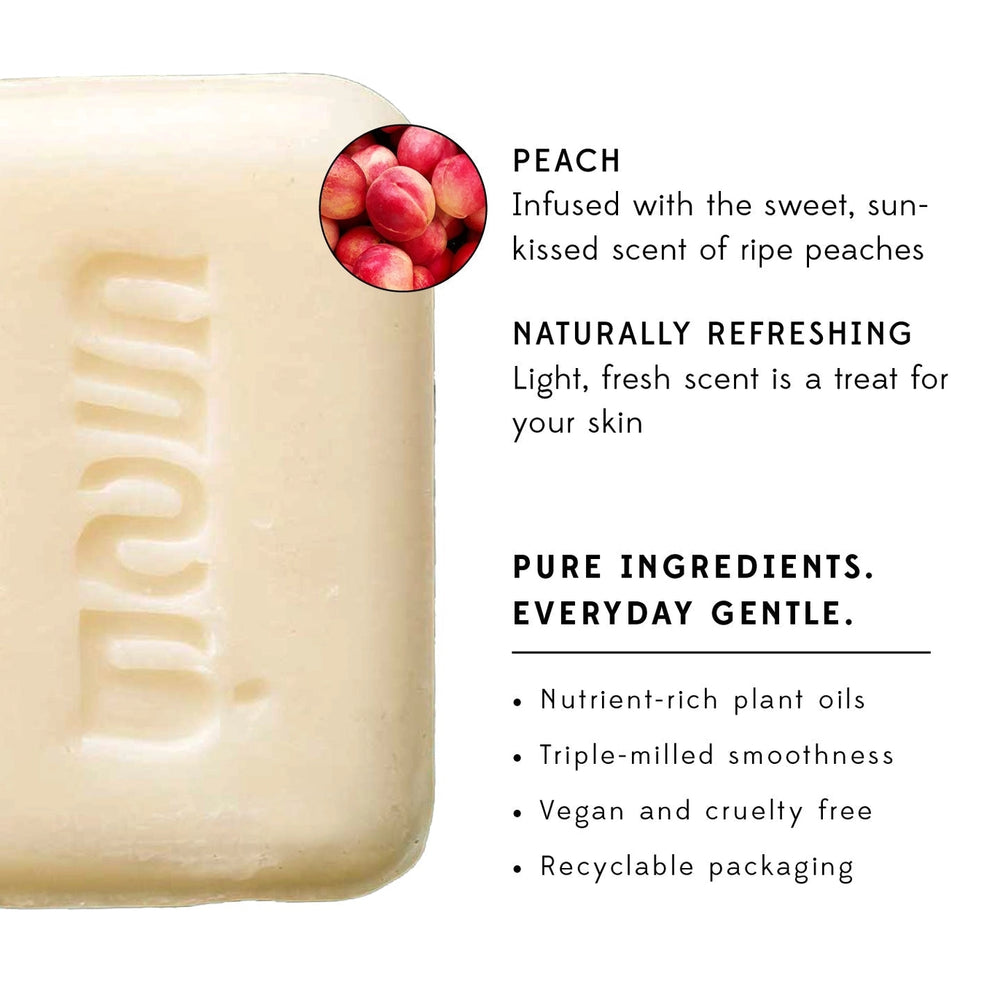 Bar of soap with peach scent description on a white background