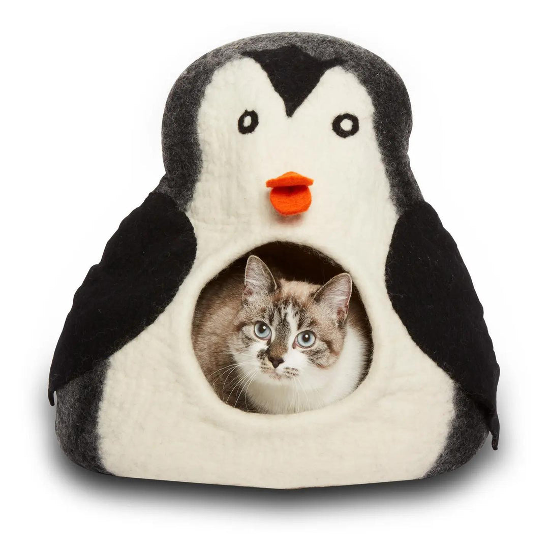 Penguin-shaped pet cave with a cat inside on a white background