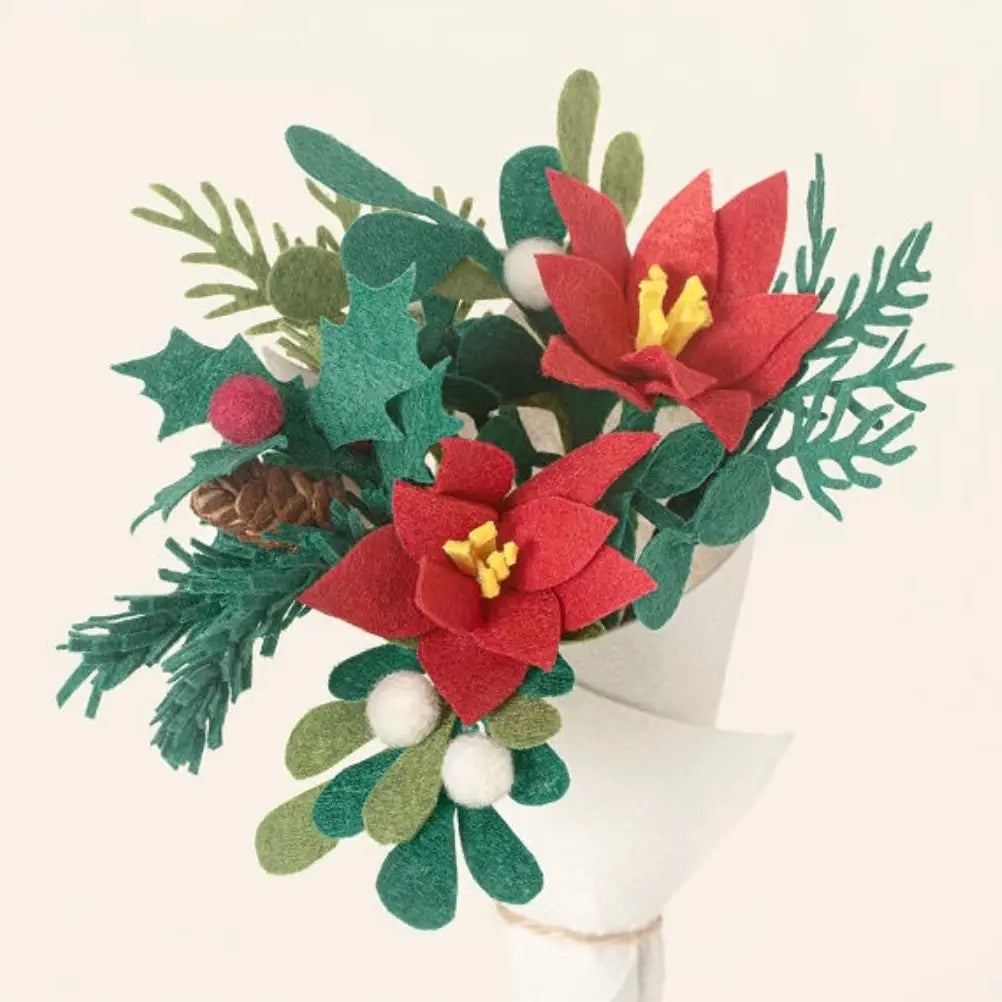 A petite holiday bouquet with holly, poinsettias and other greenery. 