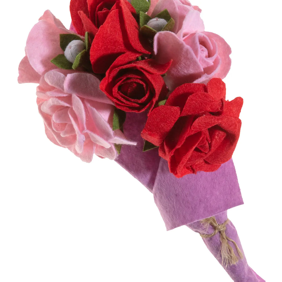 Bouquet of pink and red artificial flowers on a white background