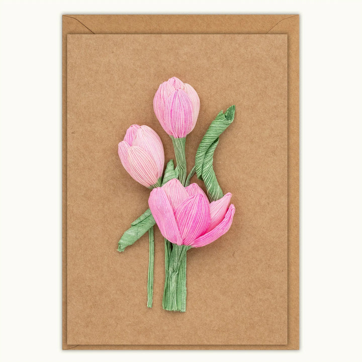 Card with pink tulips on a brown background