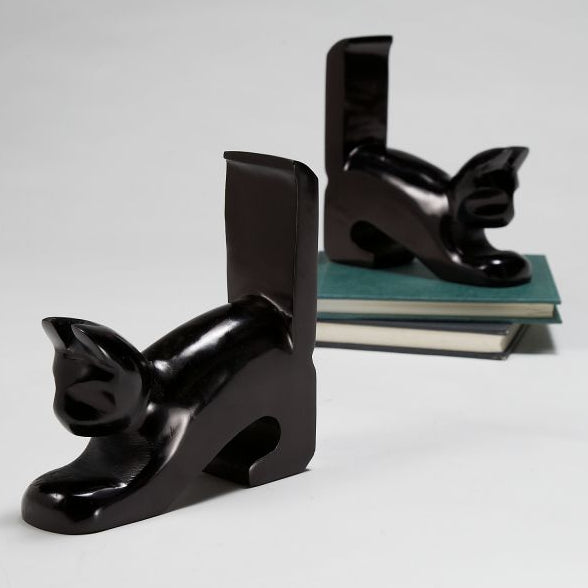 Black cat-shaped bookends on a white background