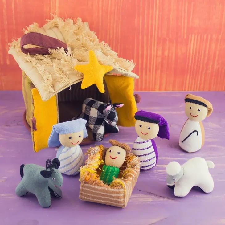 Child-friendly playhouse nativity scene with Joseph, Mary, Jesus, animals, and the animal shed. 