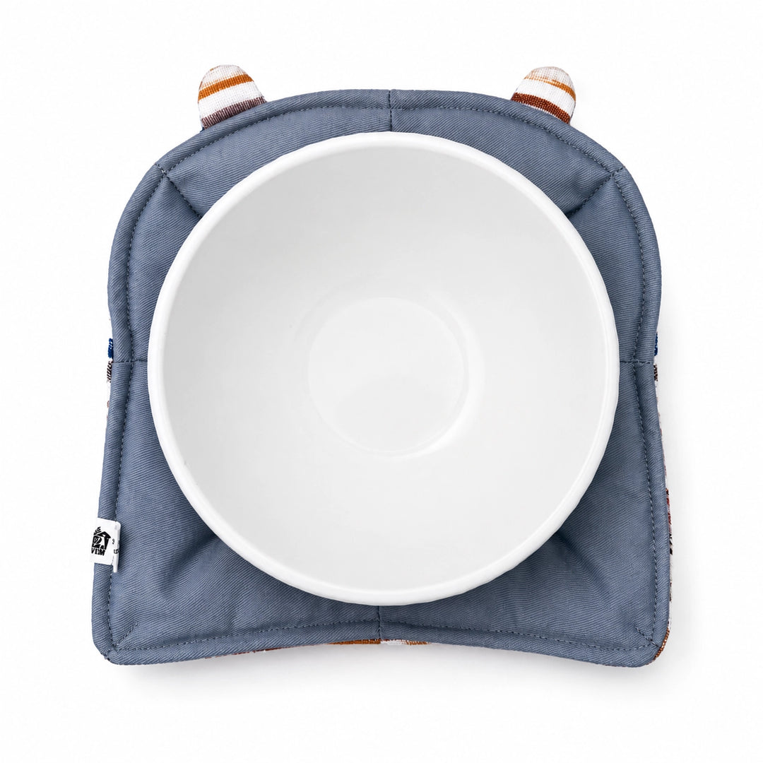 White bowl on a blue bowl cozy with a white background