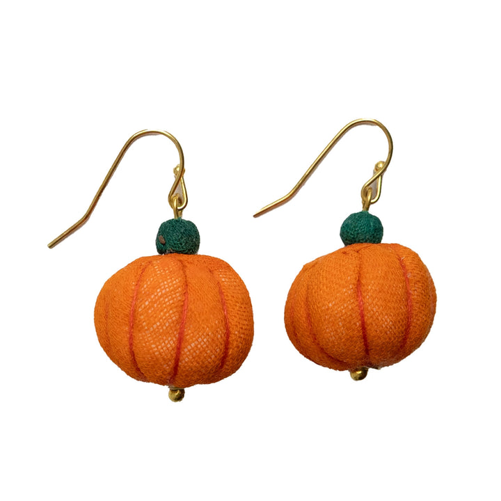 Pumpkin-shaped earrings with green beads on gold hooks against a white background