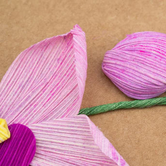 Pink yarn flower on a brown background