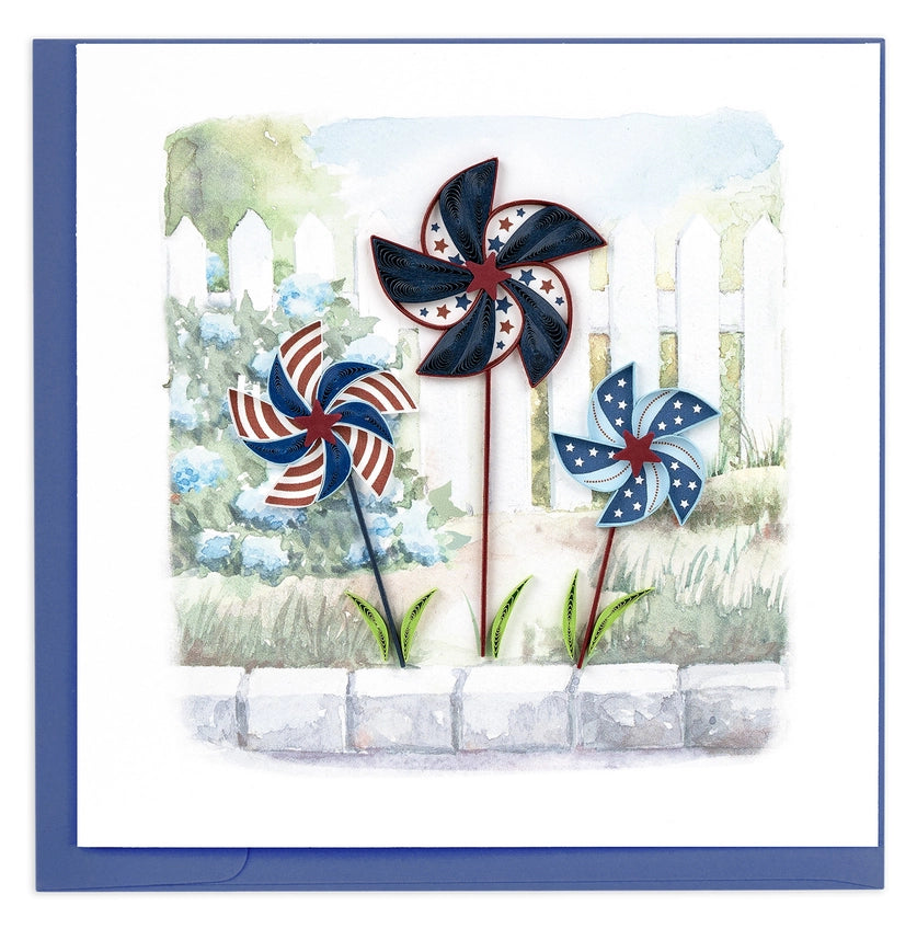 Three patriotic pinwheels decorations on a card with a scenic background.
