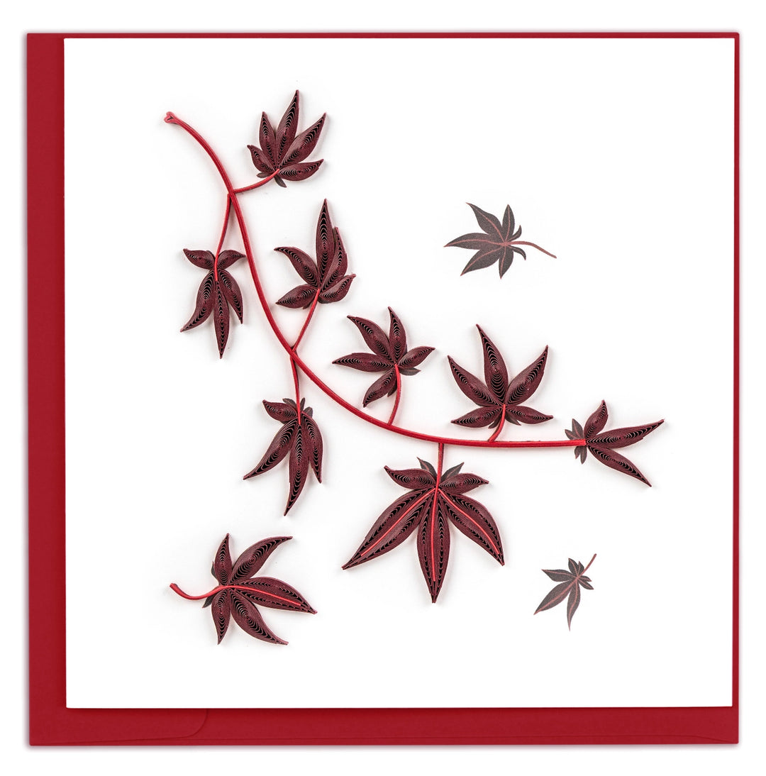 Decorative quilling card with red maple leaf design on a white background