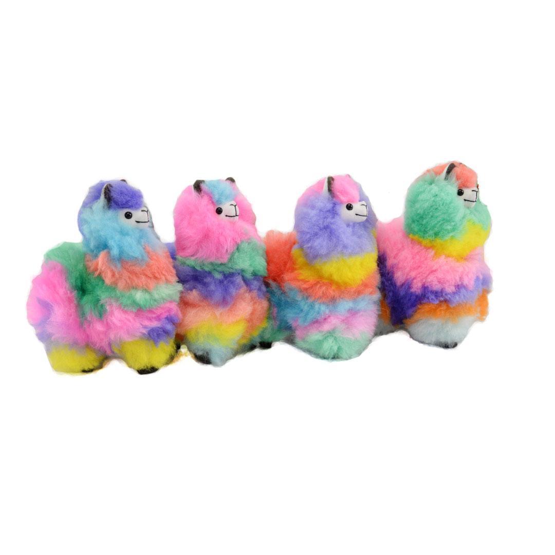 Four colorful rainbow plush alpaca llamas on a white background