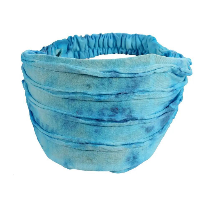 A light blue razor cut headband on white background.